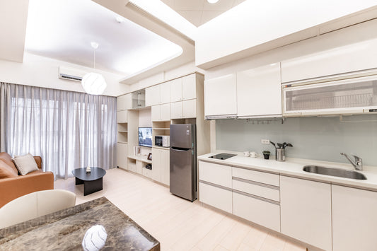 Kolette Home Serviced Apartment - Modern minimalist kitchen and living area with warm lighting in Taipei.