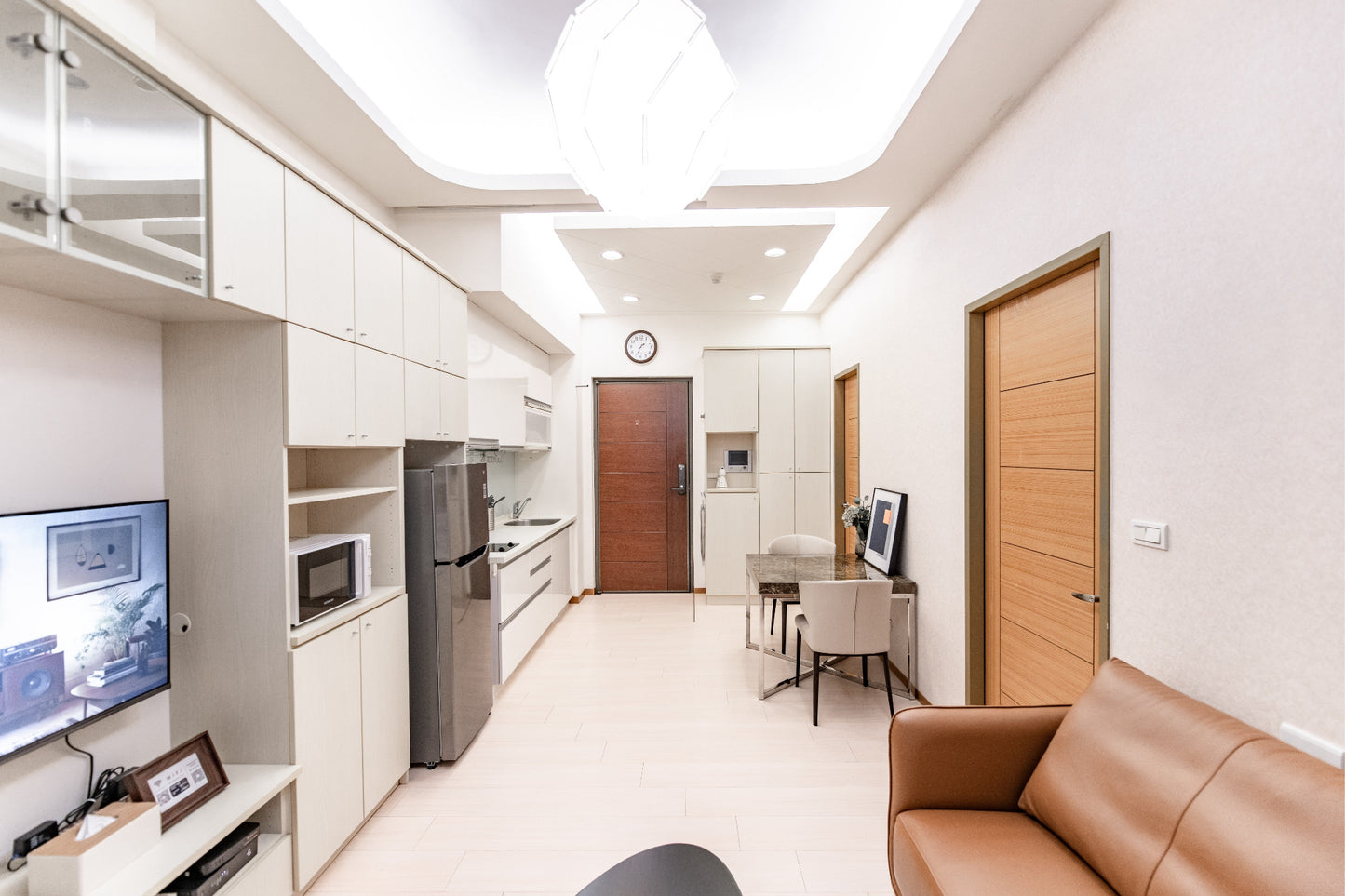 Kolette Home living room with natural light, minimalist furniture and smart TV for long-term stay in Taipei.