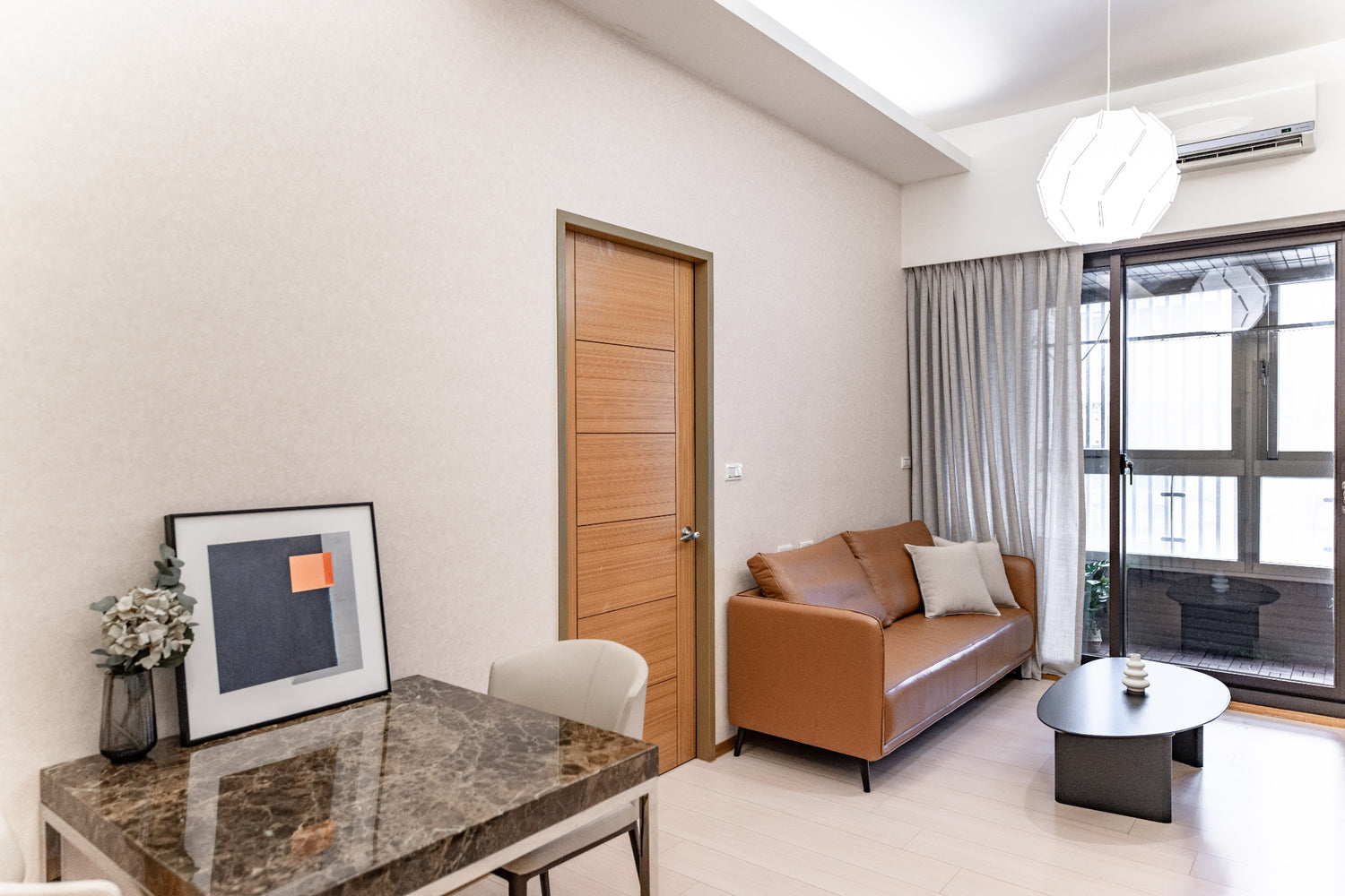 Kolette Home living room with natural light, minimalist furniture and smart TV for long-term stay in Taipei.