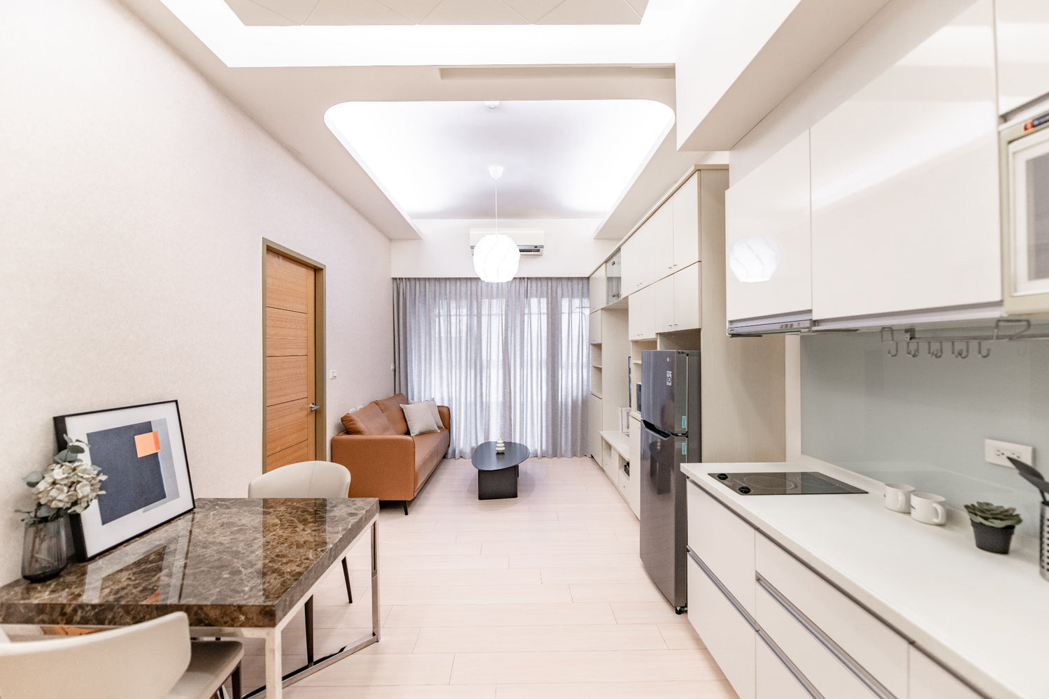 Kolette Home living room with natural light, minimalist furniture and smart TV for long-term stay in Taipei.