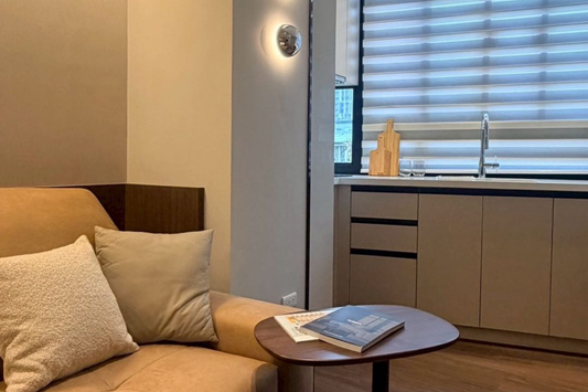 Kolette Home living room with natural light, minimalist furniture and smart TV for long-term stay in Taipei.