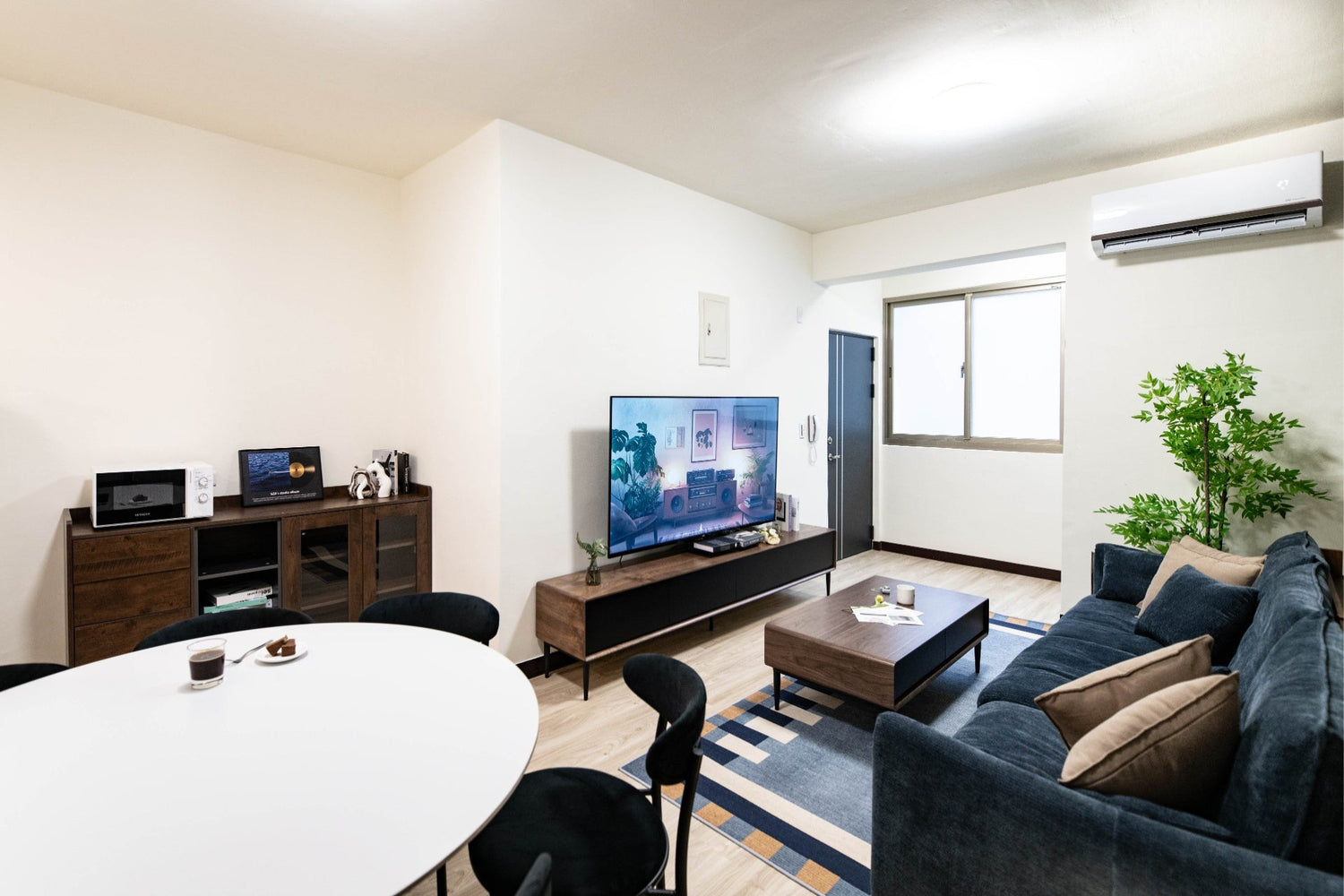 Modern living room in Taipei Taiwan short-term apartment with minimalist design - Kolette Home