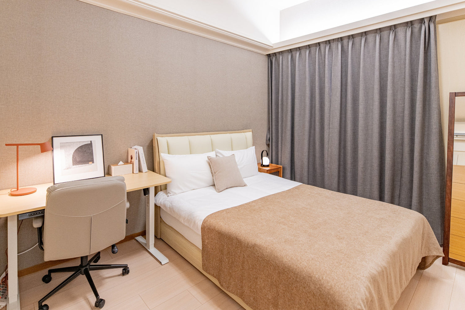 Quiet Kolette Home bedroom with premium bedding and blackout curtains for a restful night in the city.