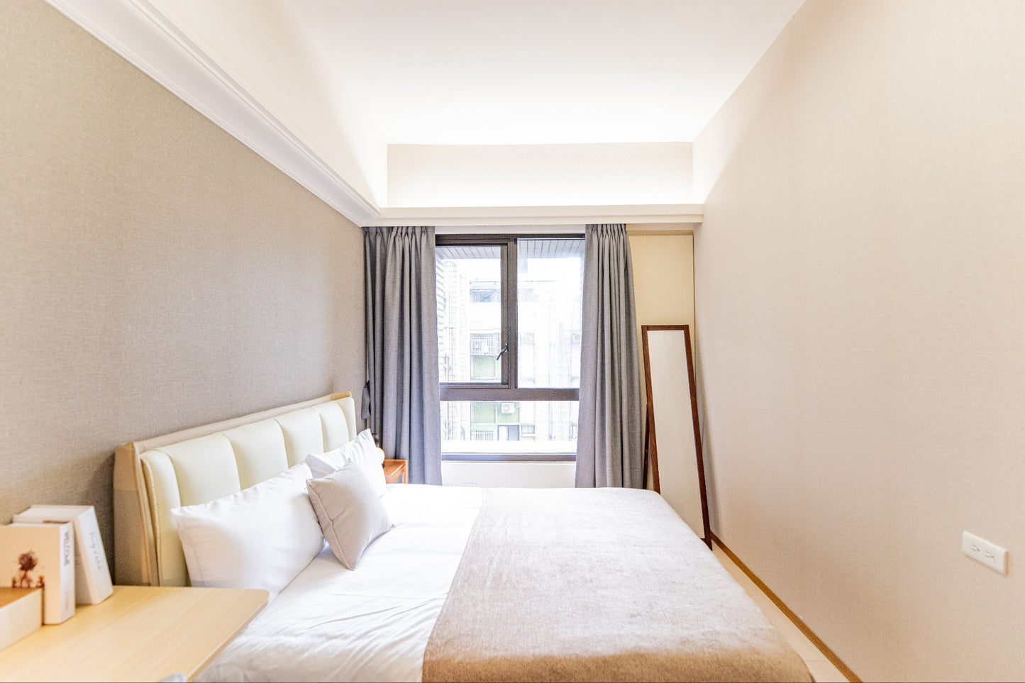 Quiet Kolette Home bedroom with premium bedding and blackout curtains for a restful night in the city.