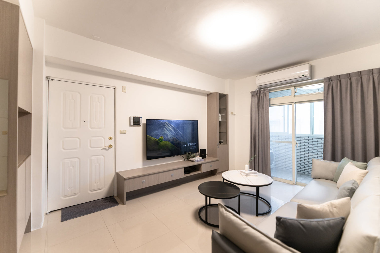 Modern living room in Taipei Taiwan short-term apartment with minimalist design - Kolette Home