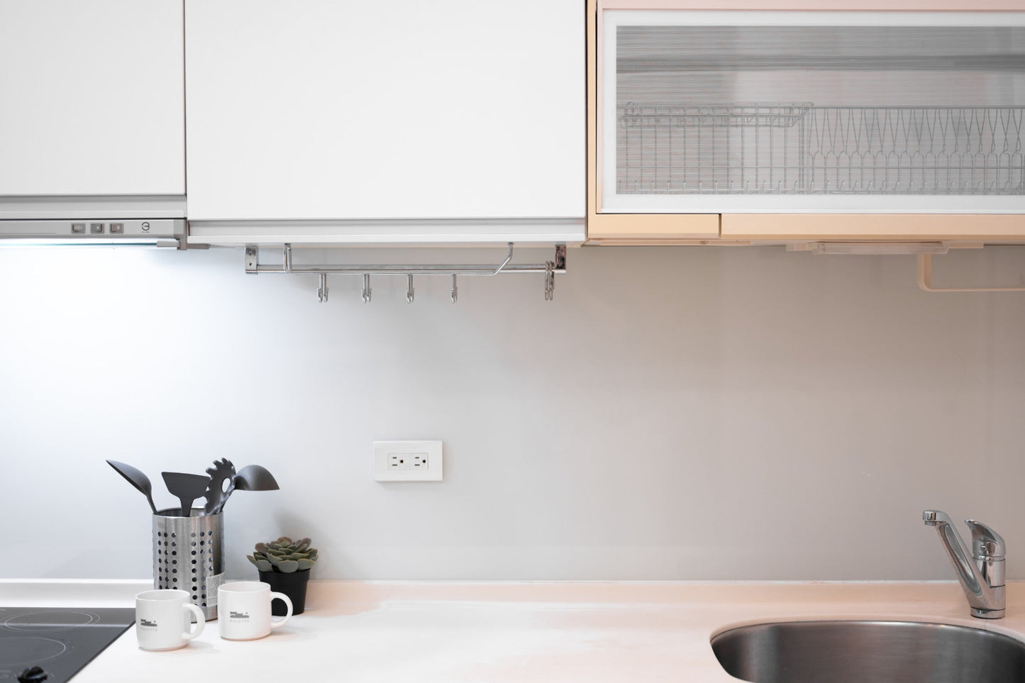 Fully-equipped modern kitchen by Kolette Home with marble countertop and induction stove for expat living.